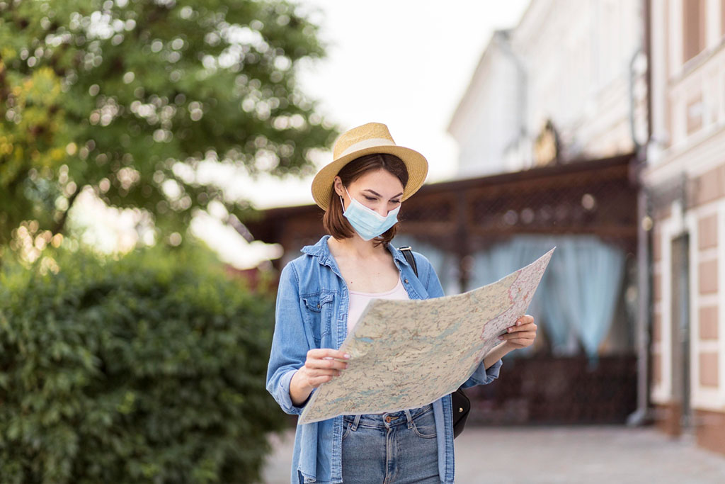 traveller with hat medical mask checking map freepik